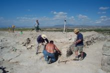 My fellow workers, real archeologists, excavating and trying to decide what the large cut stone signifies.